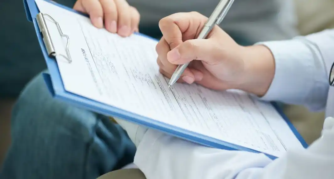 hand filling form clipboard