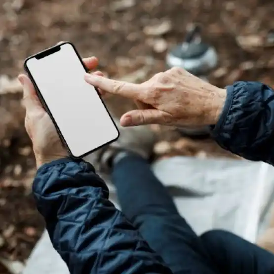 a woman holding a phone and touching the screen