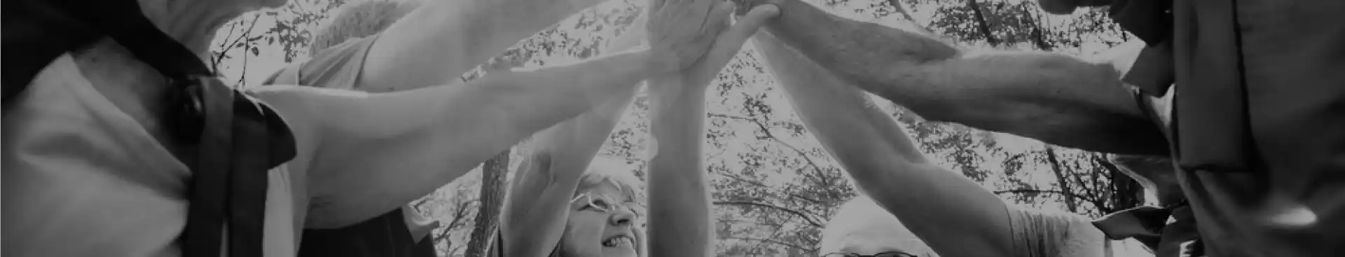 group of people putting their hands together